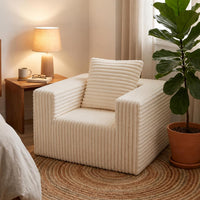 Boneless corduroy cloud chair beside a bed